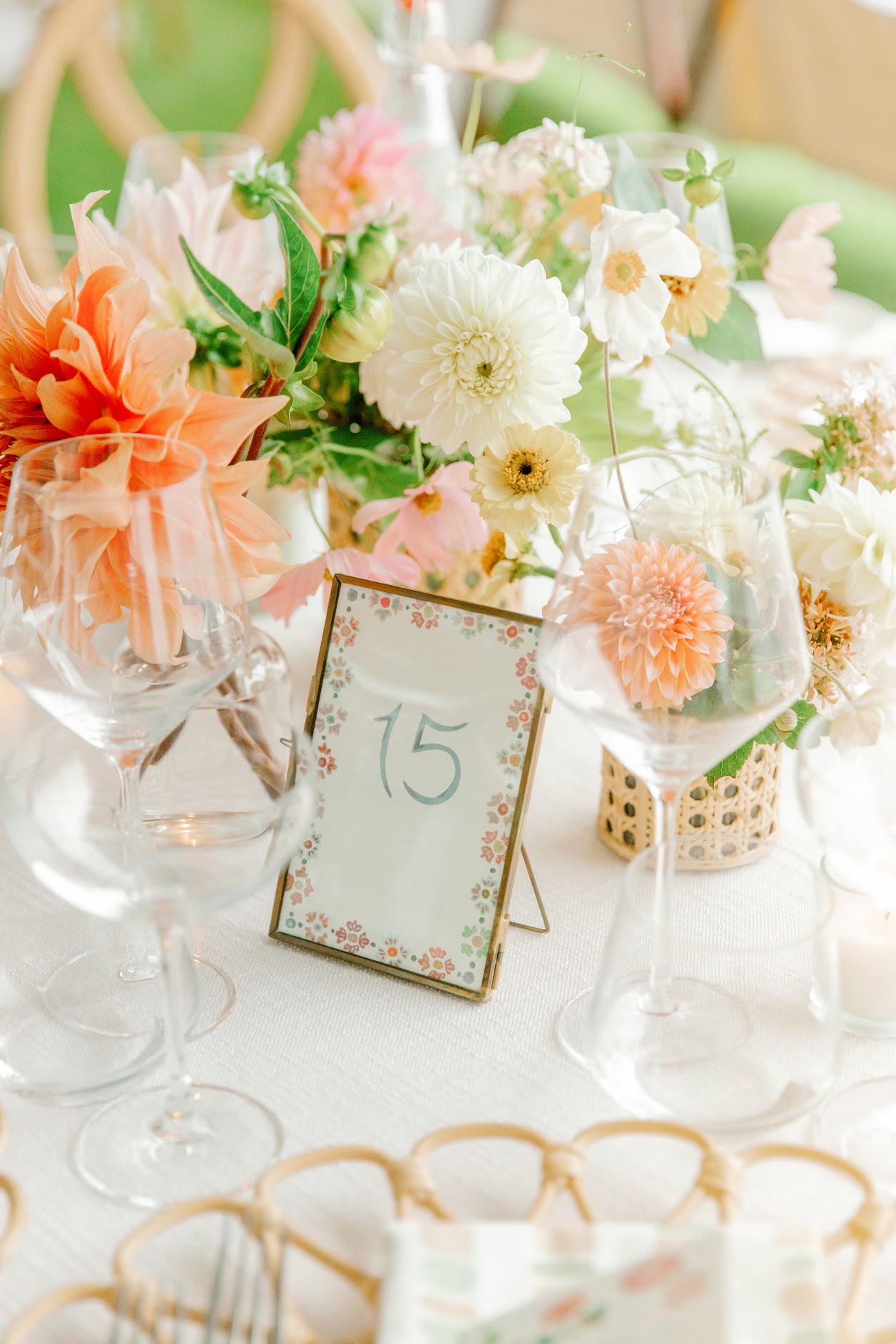 Colorful wedding reception flowers surrounding table number fifteen